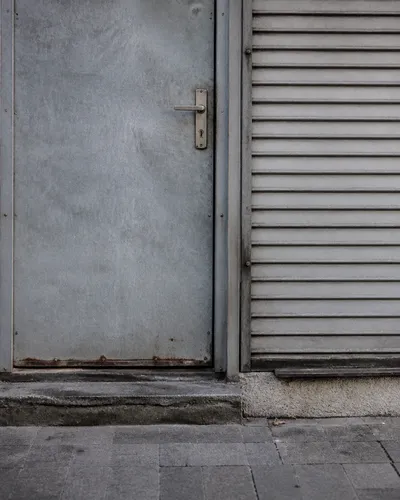 Metal shop door with a visible lock, no brand lettering.
